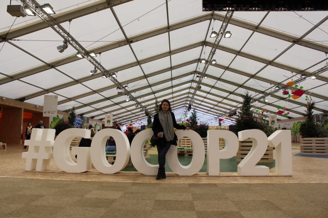 Picture of student standing infront of large plastic letters spelling #GOCOP21